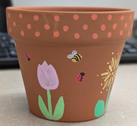 Clay pot painted with flowers and insects