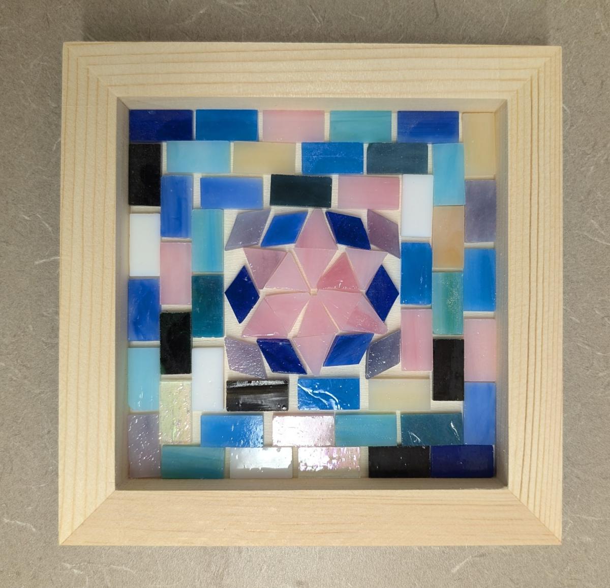 Mosiac with pink star in middle and blue tiles surrounding